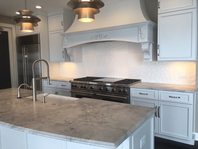 This is an example of a large traditional l-shaped separate kitchen in Other with a farmhouse sink, beaded inset cabinets, white cabinets, marble benchtops, white splashback, stainless steel appliances, dark hardwood floors and with island.
