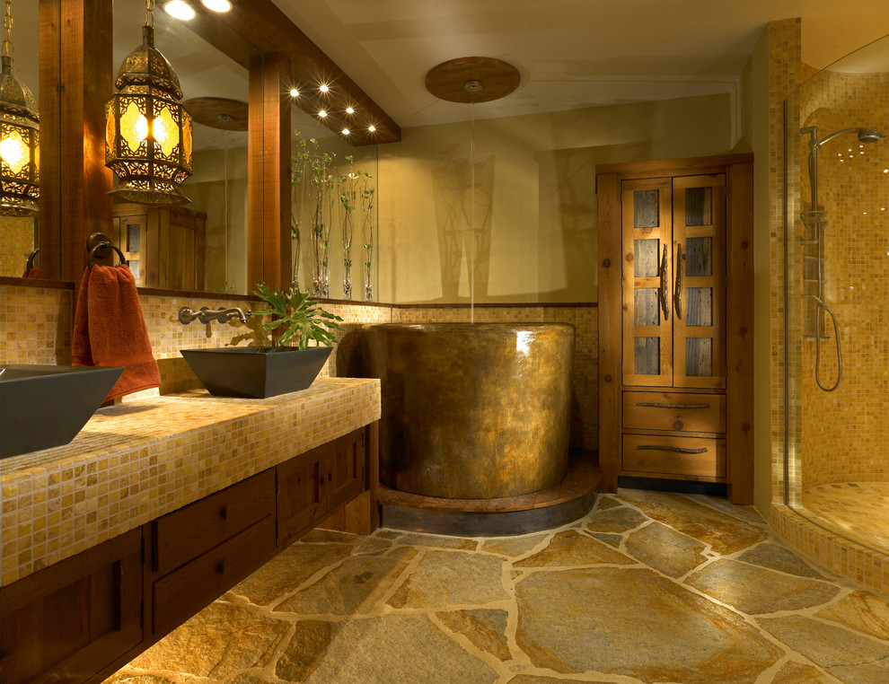 Mid-sized country master bathroom in Orlando with a japanese tub, a vessel sink, tile benchtops, shaker cabinets, dark wood cabinets, a corner shower, mosaic tile, beige walls, slate floors, brown tile and yellow benchtops.