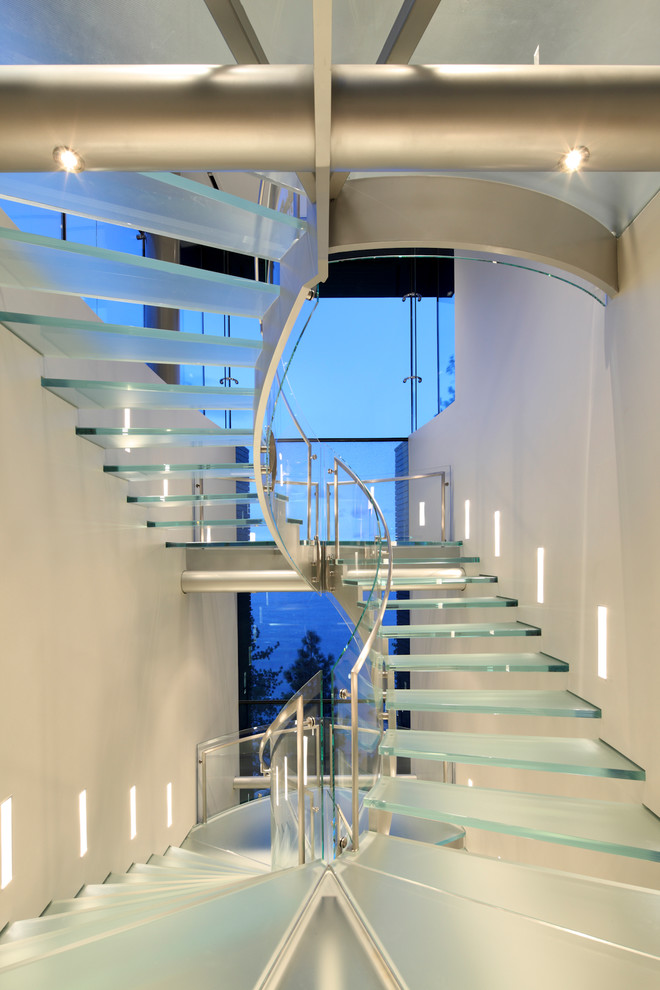 Photo of a contemporary glass staircase in Other with open risers.