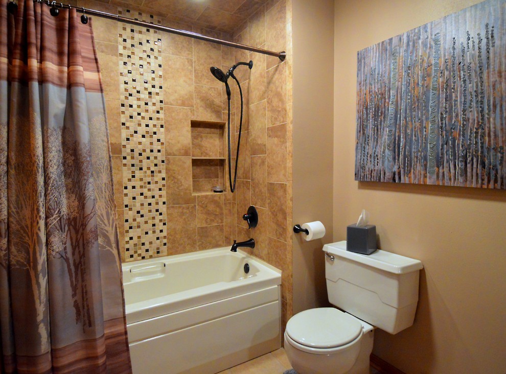 This is an example of a mid-sized transitional 3/4 bathroom in Milwaukee with an alcove tub, a shower/bathtub combo, a two-piece toilet, brown tile, stone tile, beige walls, cement tiles, a drop-in sink, beige floor and a shower curtain.