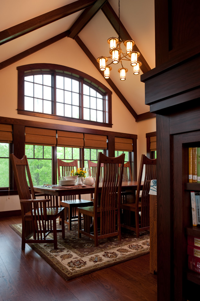 This is an example of a traditional separate dining room in Minneapolis with beige walls and dark hardwood floors.