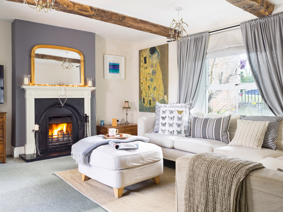 Mid-sized country enclosed living room in Wiltshire with beige walls, carpet, a standard fireplace, a metal fireplace surround and grey floor.