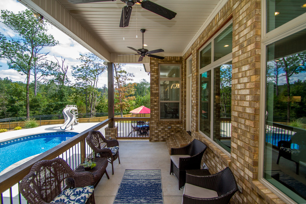 Mid-sized traditional backyard deck in Little Rock with a roof extension.