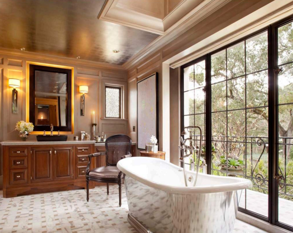 Inspiration for an expansive mediterranean master bathroom in San Francisco with a freestanding tub, white tile, brown walls, recessed-panel cabinets and medium wood cabinets.