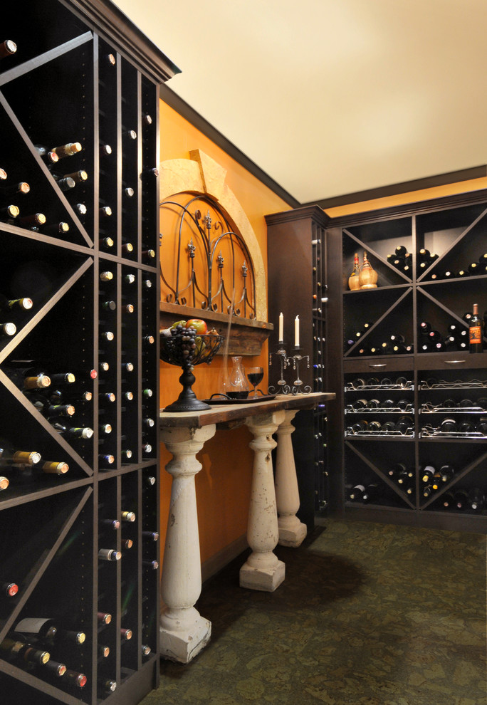 Mid-sized mediterranean wine cellar in New York with cork floors and diamond bins.