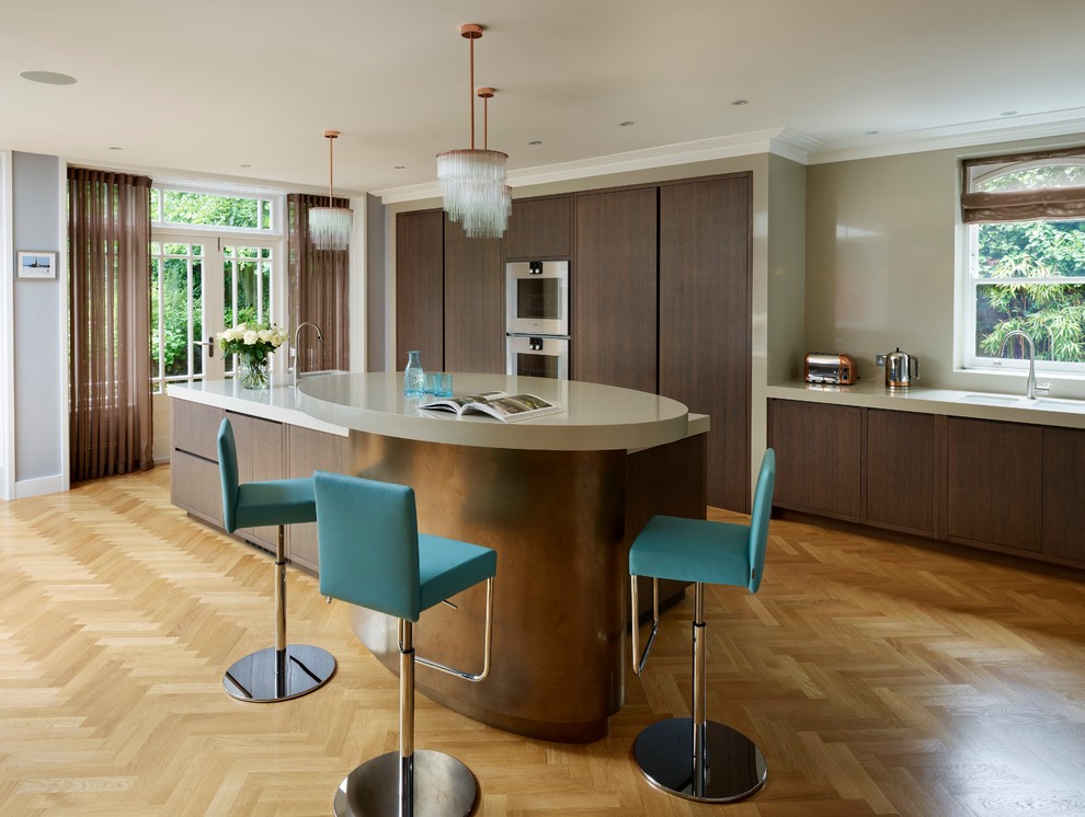 Contemporary kitchen in London with flat-panel cabinets, dark wood cabinets, granite benchtops, panelled appliances, medium hardwood floors, with island, a double-bowl sink and beige splashback.