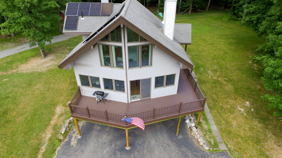 Large mountain style second story mixed material railing deck photo with no cover