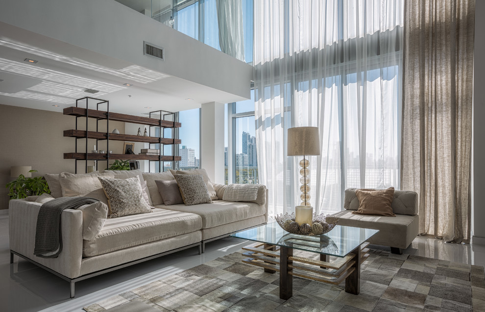 This is an example of a contemporary living room in Miami with beige walls.