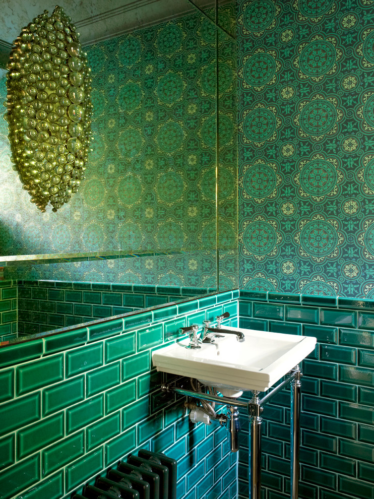 Photo of a transitional powder room in Other with green tile, subway tile, green walls and a console sink.