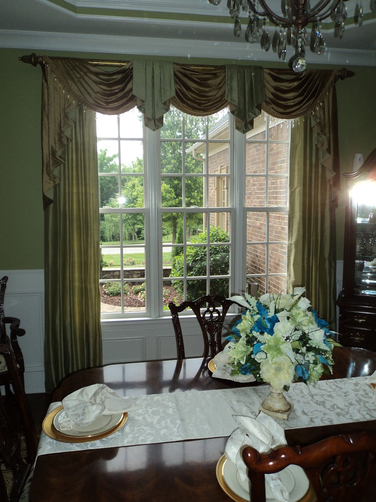 Photo of a mid-sized traditional separate dining room in Charlotte with green walls, medium hardwood floors and no fireplace.