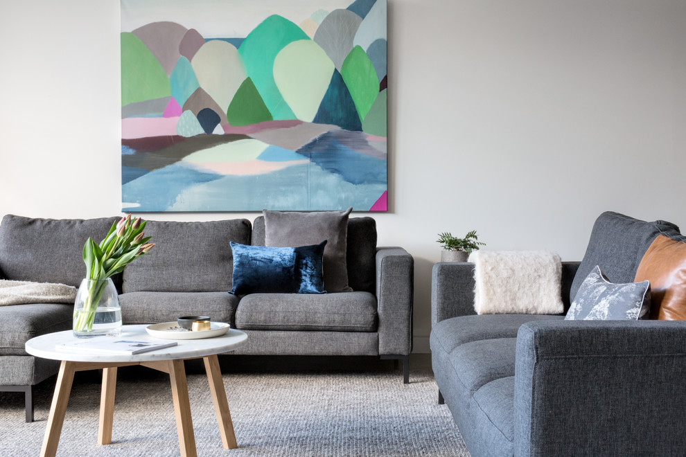 Photo of a contemporary living room in Melbourne with white walls and carpet.