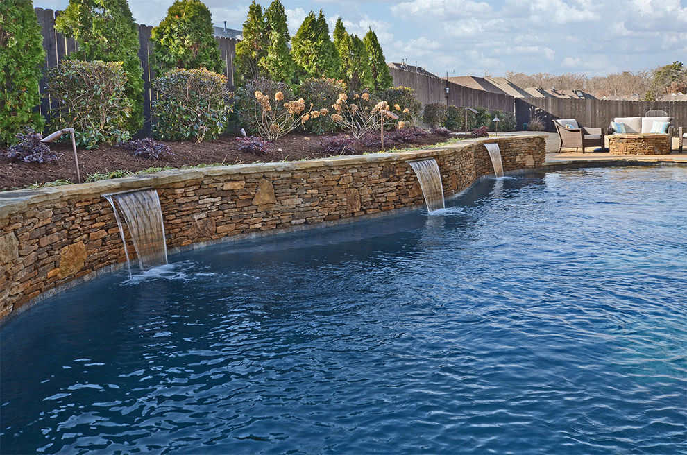 Pool fountain - large tropical backyard custom-shaped lap pool fountain idea