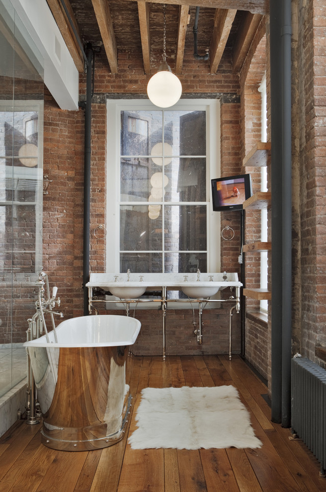 Photo of a large industrial master bathroom in New York with a freestanding tub, an alcove shower, red walls, medium hardwood floors, a console sink, marble benchtops, open cabinets, medium wood cabinets, red tile and an open shower.