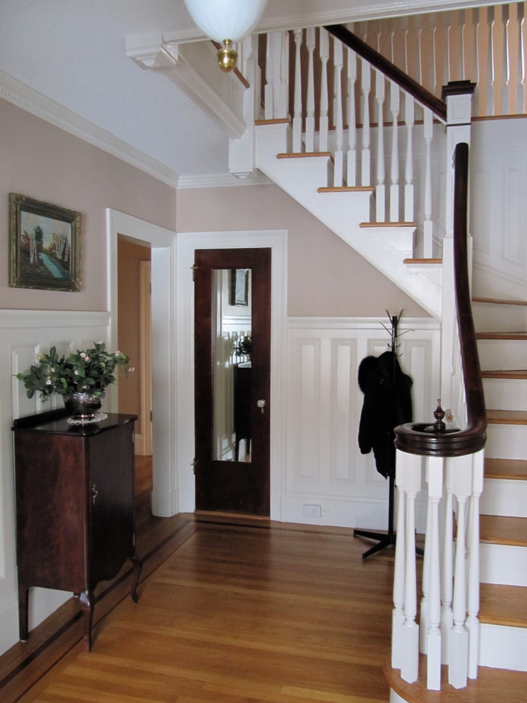 This is an example of a traditional entryway in Providence with beige walls and medium hardwood floors.