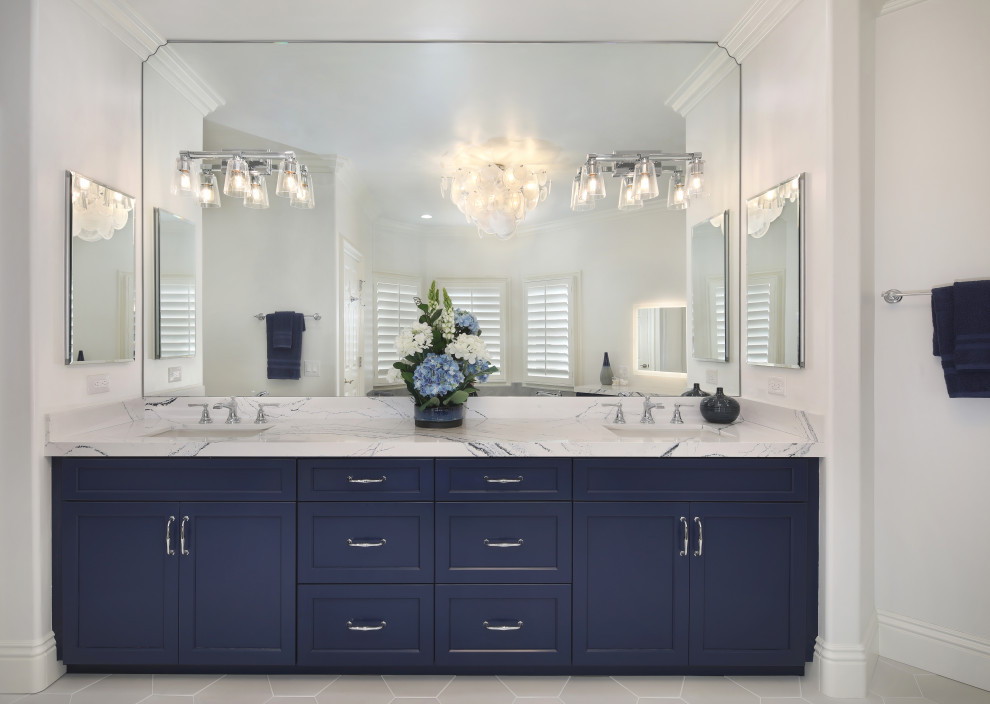 Inspiration for a large transitional master bathroom in Orange County with shaker cabinets, blue cabinets, a drop-in tub, a double shower, a one-piece toilet, white tile, porcelain tile, white walls, porcelain floors, an undermount sink, engineered quartz benchtops, white floor, a hinged shower door, blue benchtops, a shower seat, a double vanity and a built-in vanity.