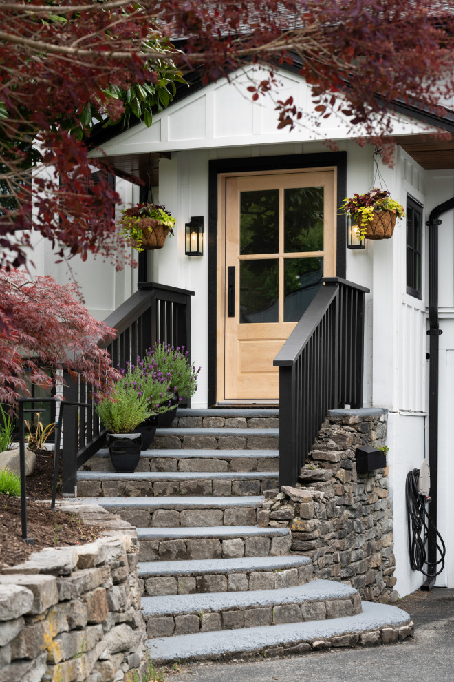 Design ideas for a large modern front door in Vancouver with white walls, a single front door and a light wood front door.