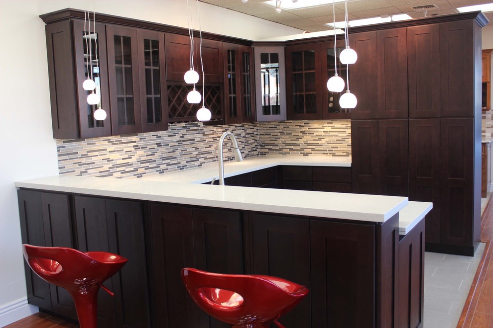 Open concept kitchen - small southwestern l-shaped ceramic tile open concept kitchen idea in Phoenix with an undermount sink, shaker cabinets, dark wood cabinets, granite countertops, multicolored backsplash, glass tile backsplash, stainless steel appliances and an island
