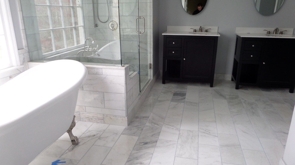 Design ideas for a mid-sized modern master bathroom in Atlanta with shaker cabinets, black cabinets, a claw-foot tub, an alcove shower, a one-piece toilet, gray tile, white tile, porcelain tile, grey walls, marble floors, an undermount sink and solid surface benchtops.