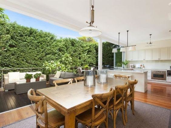 Photo of a large traditional open plan dining in Sydney with white walls and medium hardwood floors.
