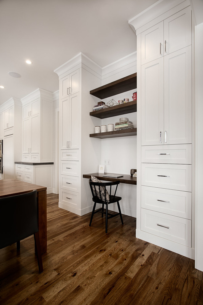 Example of a large transitional u-shaped eat-in kitchen design in Calgary with shaker cabinets, paneled appliances and an island