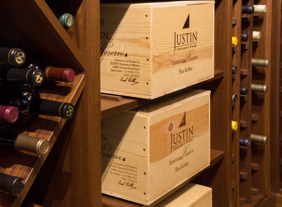 Mid-sized traditional wine cellar in Los Angeles with storage racks and beige floor.