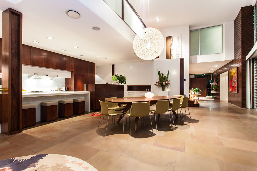 Photo of a large contemporary galley kitchen/dining combo in Gold Coast - Tweed with an integrated sink, medium wood cabinets, granite benchtops, white splashback, stainless steel appliances, slate floors and with island.