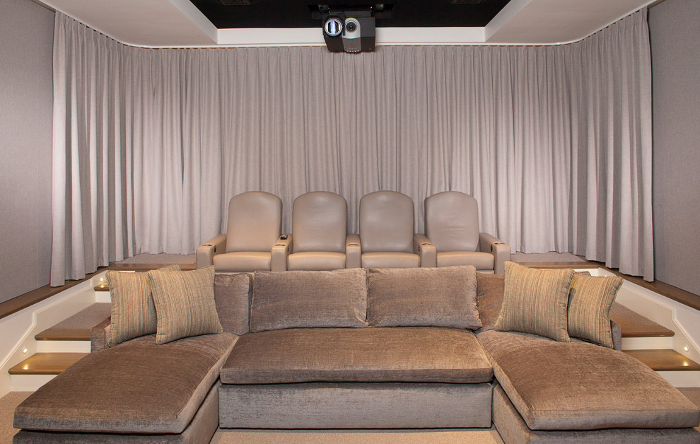 Design ideas for a large contemporary enclosed home theatre in Boston with beige walls and a projector screen.