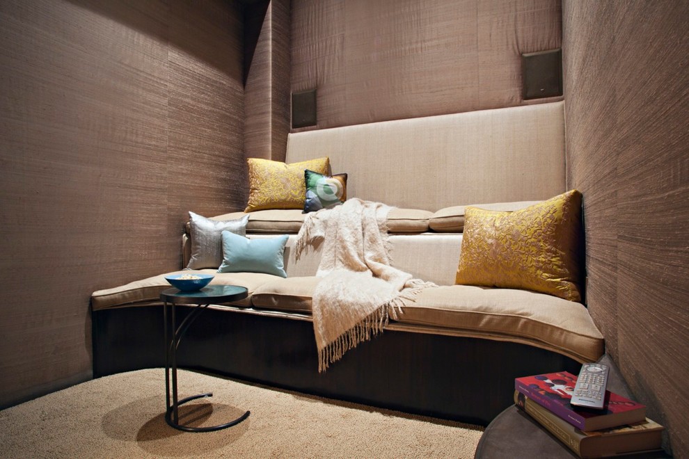 This is an example of a small contemporary enclosed home theatre in New York with carpet and brown walls.
