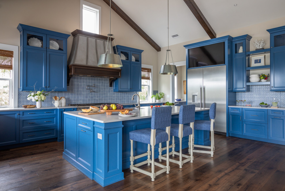 Inspiration for a beach style l-shaped kitchen in Jacksonville with an undermount sink, recessed-panel cabinets, blue cabinets, blue splashback, stainless steel appliances, dark hardwood floors, with island, brown floor, white benchtop and exposed beam.