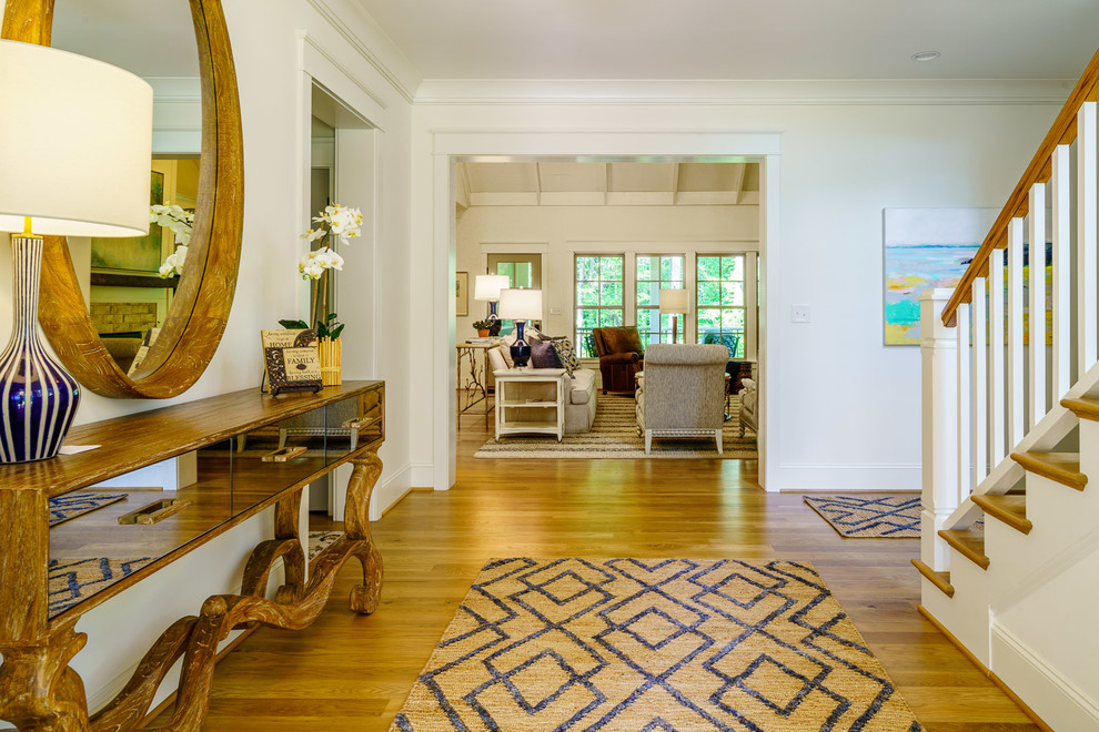 Inspiration for a mid-sized transitional medium tone wood floor and brown floor front door remodel with white walls and a medium wood front door