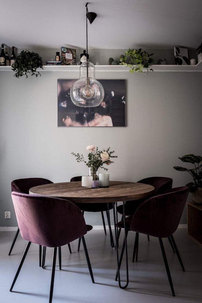 This is an example of a small scandinavian separate dining room in Gothenburg with grey walls and grey floor.