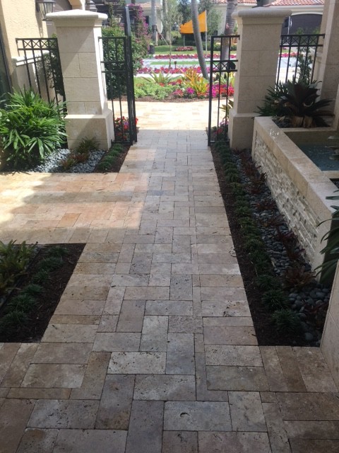 Example of a large transitional travertine floor front door design in Miami with blue walls and a glass front door