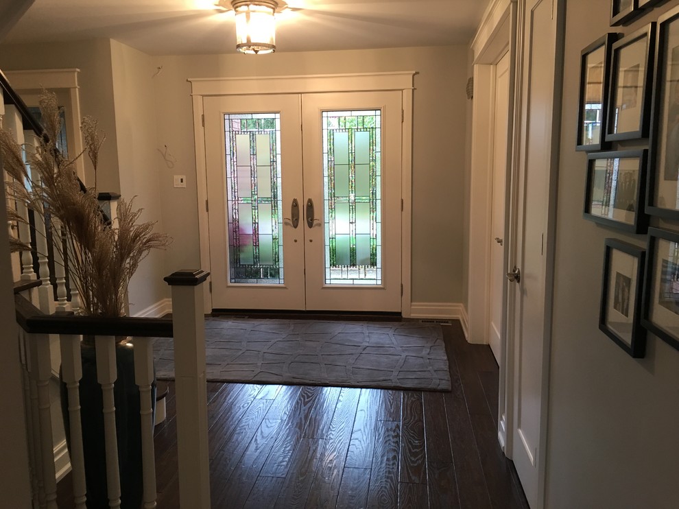 Example of a mid-sized transitional dark wood floor foyer design in Toronto with gray walls
