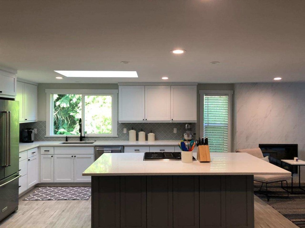 Mid-sized transitional u-shaped porcelain tile and gray floor eat-in kitchen photo in Seattle with an undermount sink, recessed-panel cabinets, white cabinets, quartzite countertops, gray backsplash, ceramic backsplash, stainless steel appliances, an island and white countertops