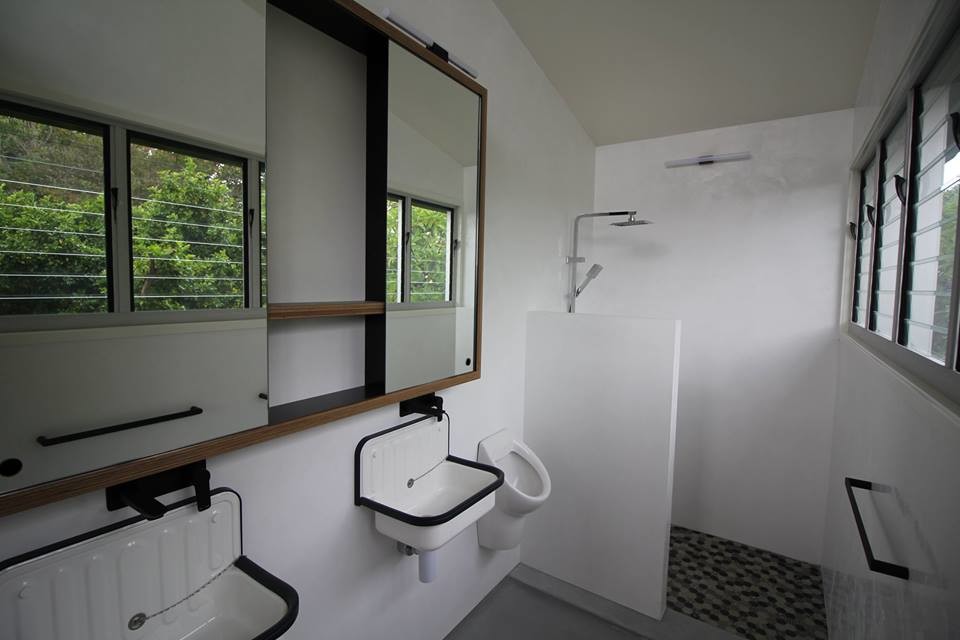 Design ideas for a mid-sized industrial bathroom in Other with an alcove shower, an urinal, white tile, porcelain tile, concrete floors, a wall-mount sink and an open shower.