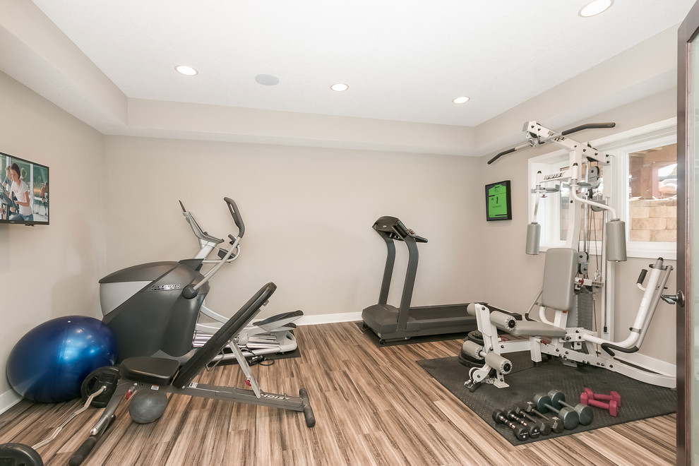 Design ideas for a large contemporary multipurpose gym in Minneapolis with beige walls, bamboo floors and brown floor.