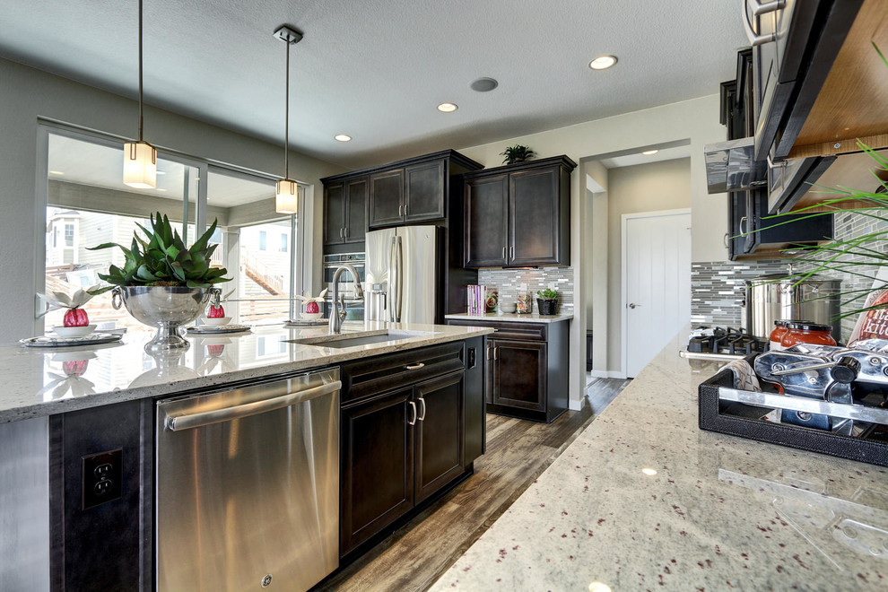 Inspiration for a mid-sized transitional l-shaped porcelain tile open concept kitchen remodel in Denver with dark wood cabinets, granite countertops, an island, an undermount sink, recessed-panel cabinets, white backsplash, mosaic tile backsplash and stainless steel appliances