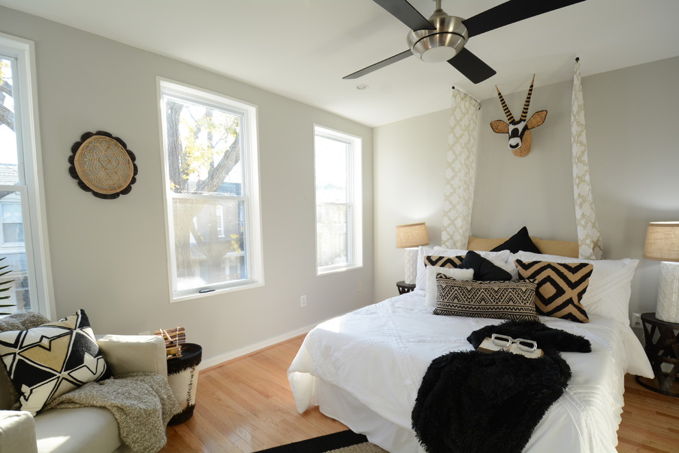 Photo of a small contemporary master bedroom in DC Metro with black walls, bamboo floors and yellow floor.