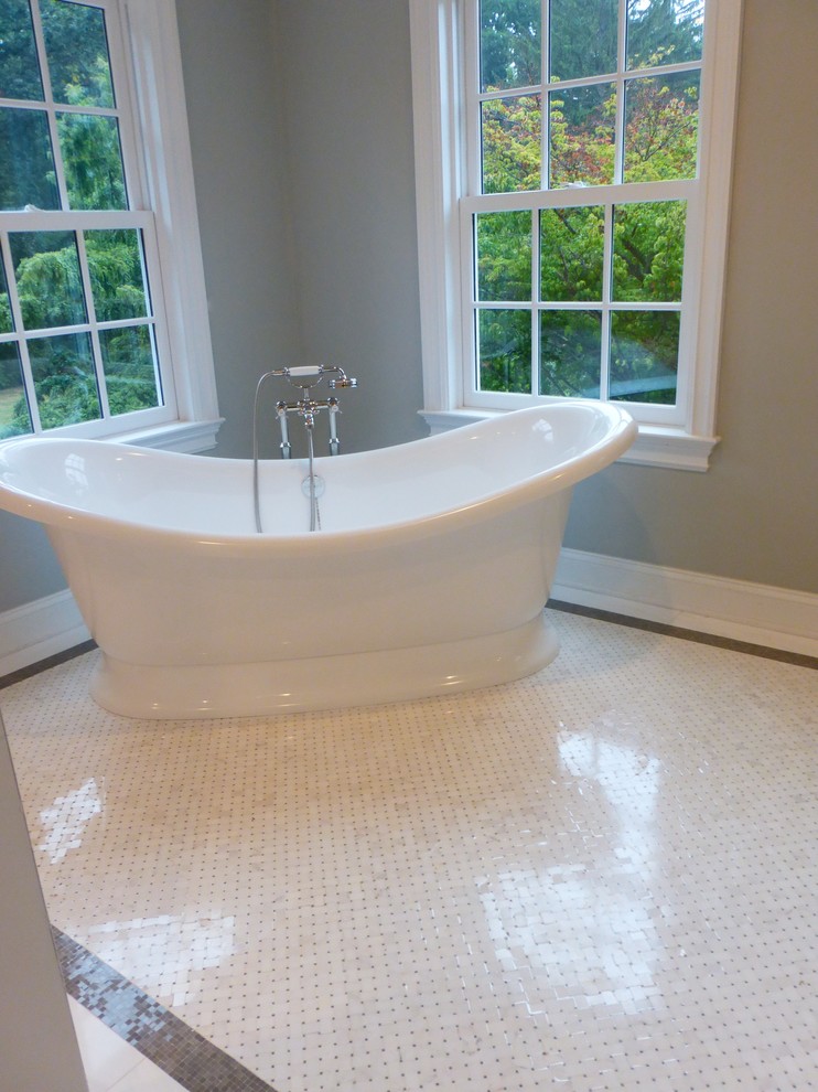 Design ideas for a transitional bathroom in New York with a freestanding tub, white tile and mosaic tile.