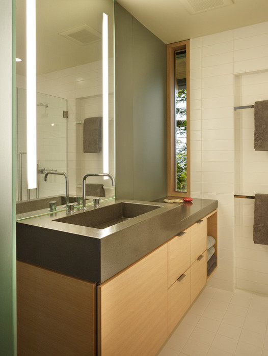 Contemporary bathroom in Seattle with flat-panel cabinets, light wood cabinets, concrete benchtops, white tile, subway tile, white walls, ceramic floors and an integrated sink.