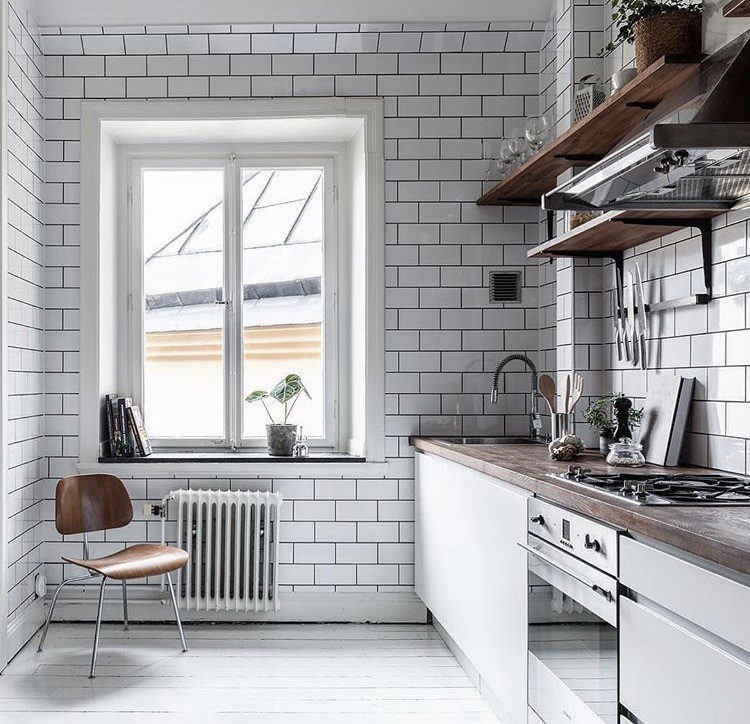 Inspiration for a mid-sized industrial single-wall kitchen in Stockholm with flat-panel cabinets, white cabinets, wood benchtops and no island.