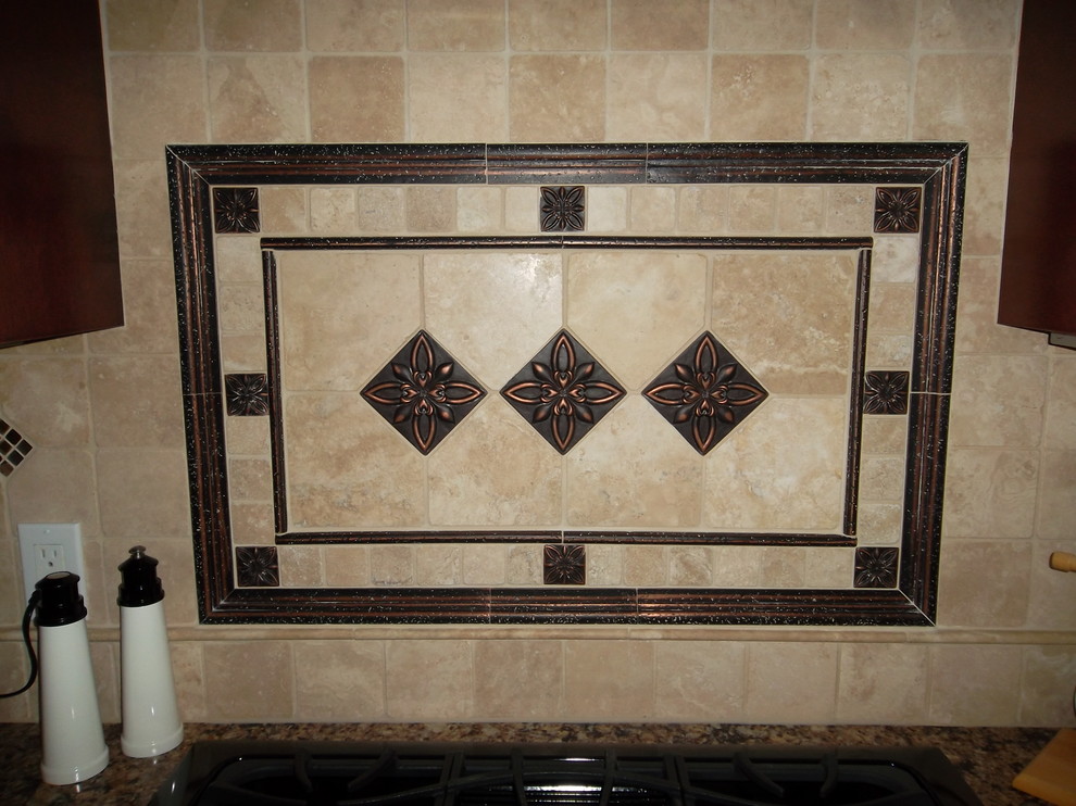Kitchen - mid-sized transitional l-shaped ceramic tile kitchen idea with a drop-in sink, dark wood cabinets, granite countertops, stone tile backsplash, stainless steel appliances, an island and raised-panel cabinets