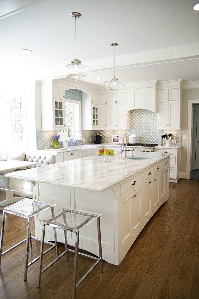 Photo of a traditional eat-in kitchen in DC Metro with recessed-panel cabinets and white cabinets.