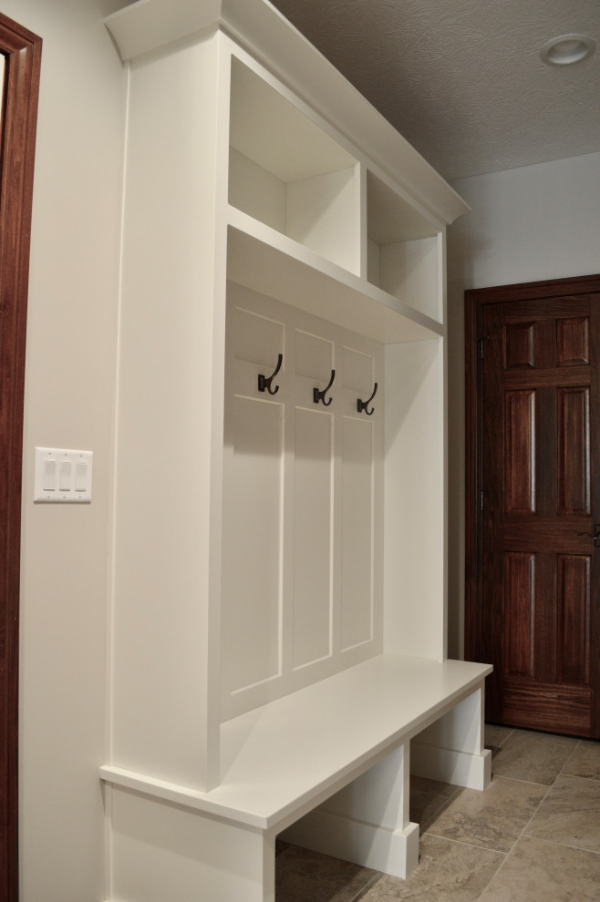 Mid-sized transitional porcelain tile and beige floor mudroom photo with gray walls and a brown front door