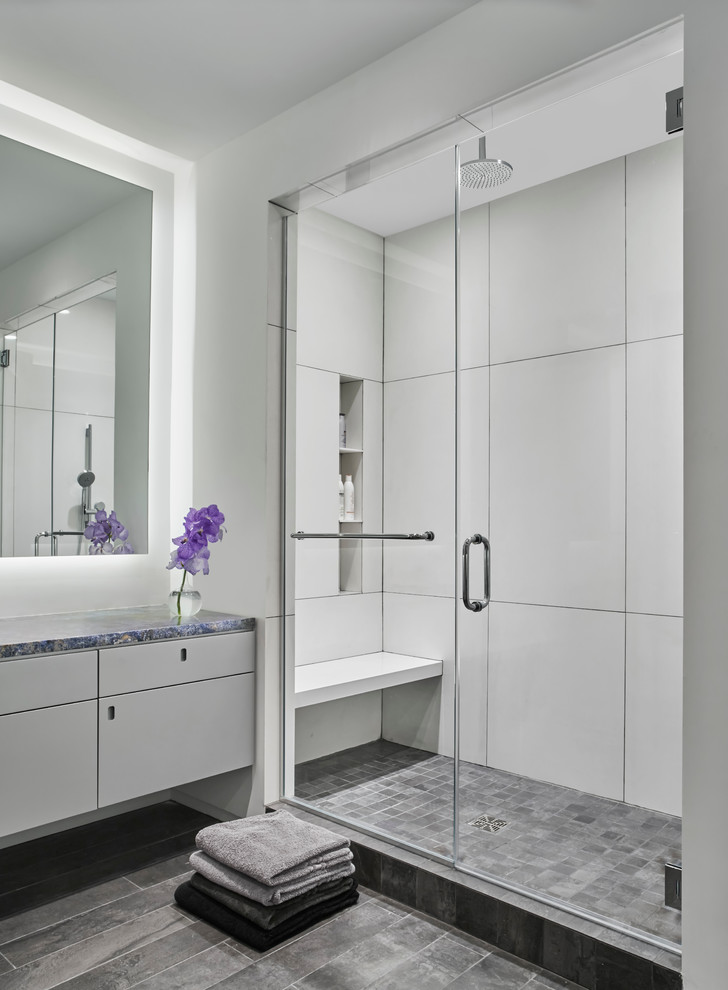 Photo of a mid-sized contemporary master bathroom in Chicago with flat-panel cabinets, grey cabinets, white tile, white walls, porcelain floors, a drop-in sink and granite benchtops.