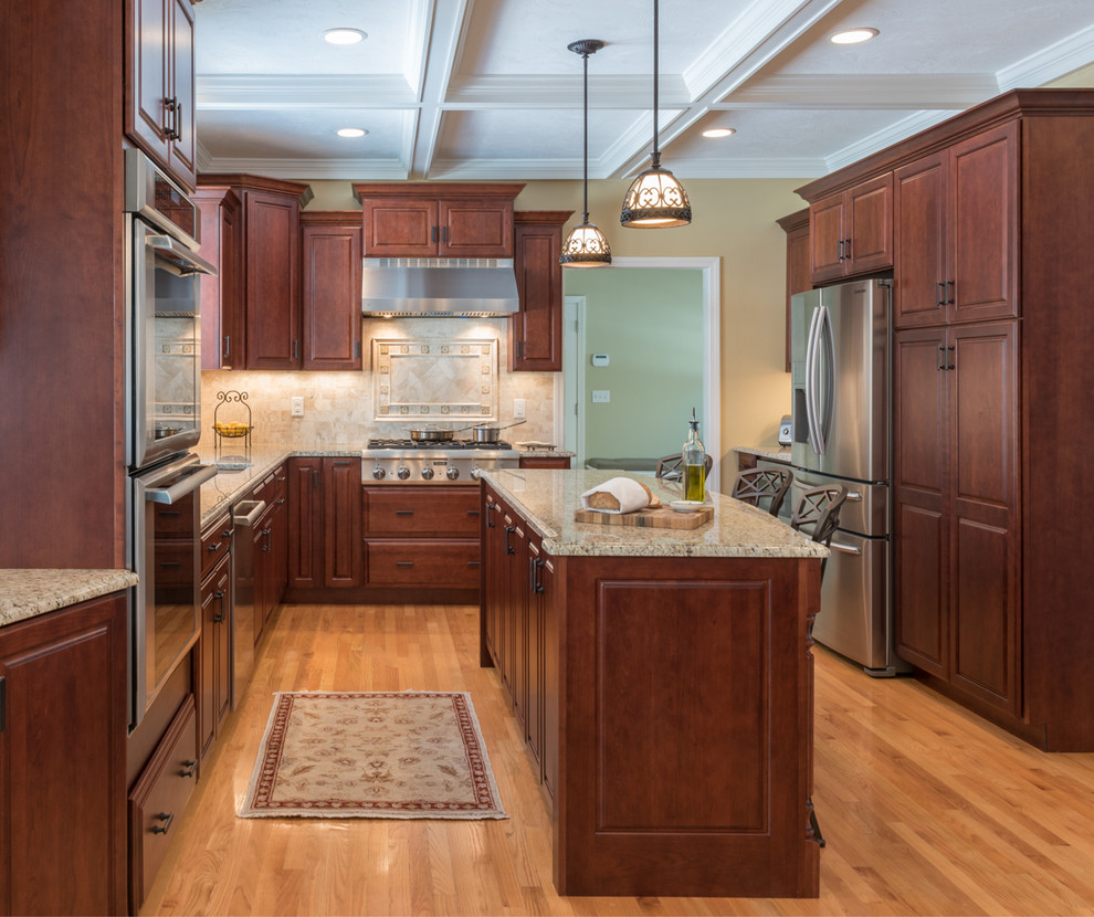 Kitchen - large transitional light wood floor kitchen idea in Boston with an undermount sink, medium tone wood cabinets, granite countertops, stone tile backsplash, stainless steel appliances and an island