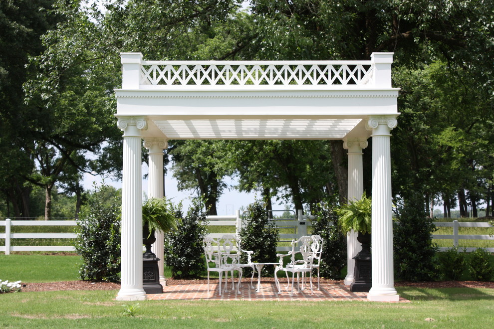 Inspiration for a traditional backyard full sun formal garden in Jackson with a garden path and brick pavers.