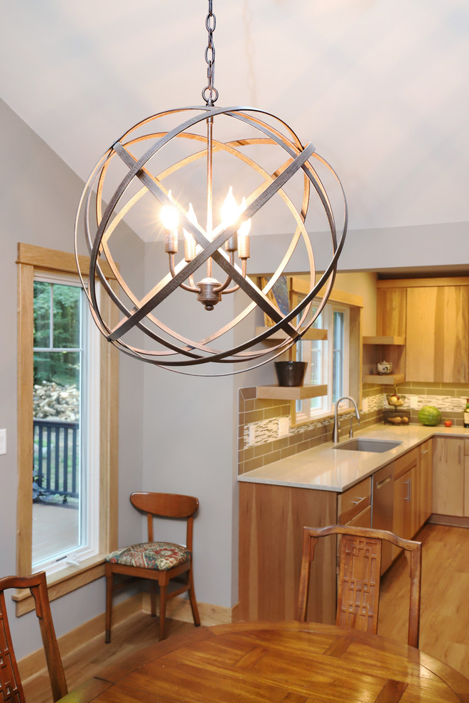 Inspiration for a mid-sized transitional u-shaped light wood floor and brown floor eat-in kitchen remodel in Grand Rapids with an undermount sink, flat-panel cabinets, light wood cabinets, quartz countertops, brown backsplash, ceramic backsplash, stainless steel appliances and an island