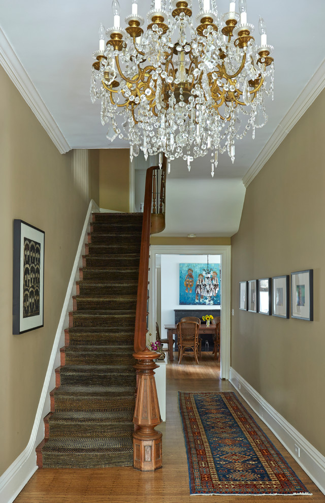 Large traditional carpeted l-shaped staircase in Chicago with wood risers.