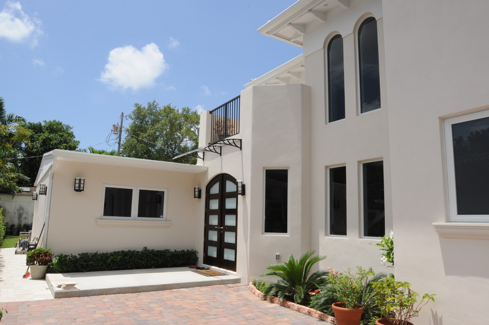 Example of a large transitional double front door design in Miami with white walls